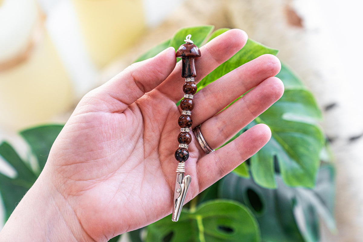 Brown mushroom beaded wand cigarette holder shown in hand