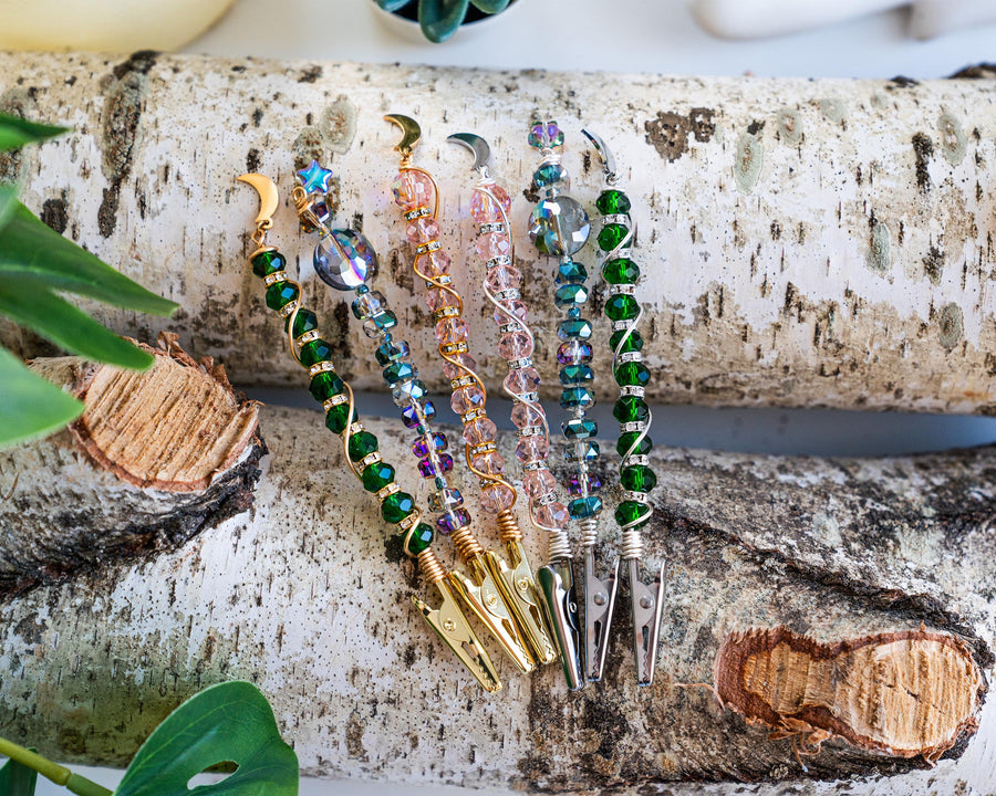 Celestial moon and star wand cigarette holders arranged on a birch display