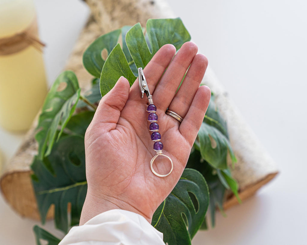 Purple beaded wand cigarette holder held in hand
