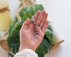 Purple beaded wand cigarette holder held in hand