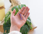 Gold-tone purple beaded wand cigarette holder shown in hand