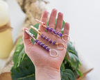 Rose-gold-tone purple beaded wand cigarette holder shown in hand