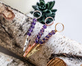 Purple beaded wand cigarette holder finish options on a birch display