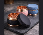 Faceted Rose Gold Trim Herb Grinder - black blue and pink staged group