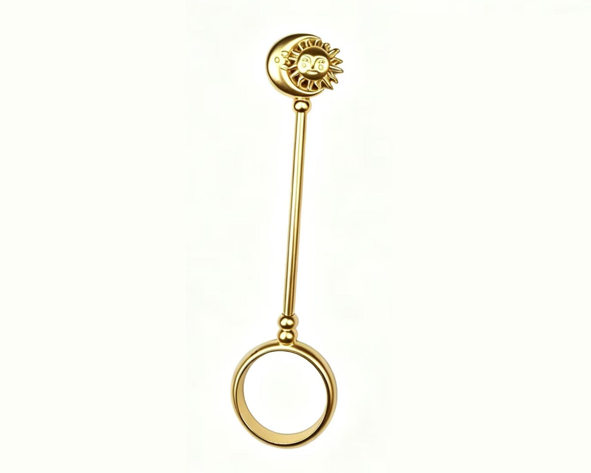 Full-length gold-tone sun and moon cigarette holder ring on a white background