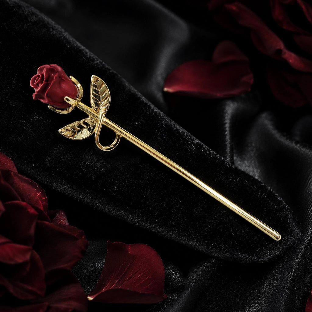 Gold rose cigarette holder on a dark floral display