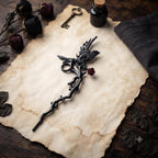 Black gothic raven cigarette holder on a parchment-style background