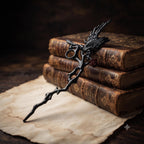 Black gothic raven cigarette holder displayed beside books