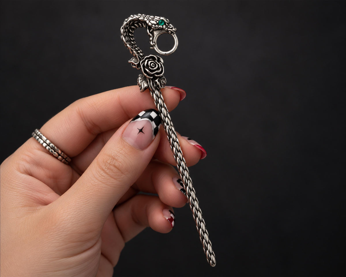 Silver-tone snake cigarette holder shown in hand