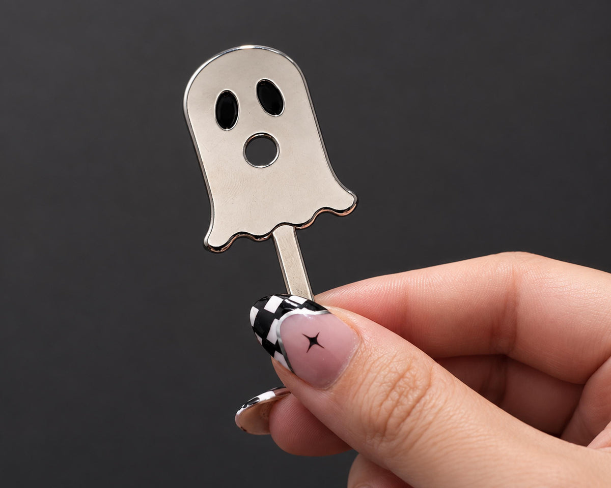 Silver-tone ghost cigarette holder shown in hand